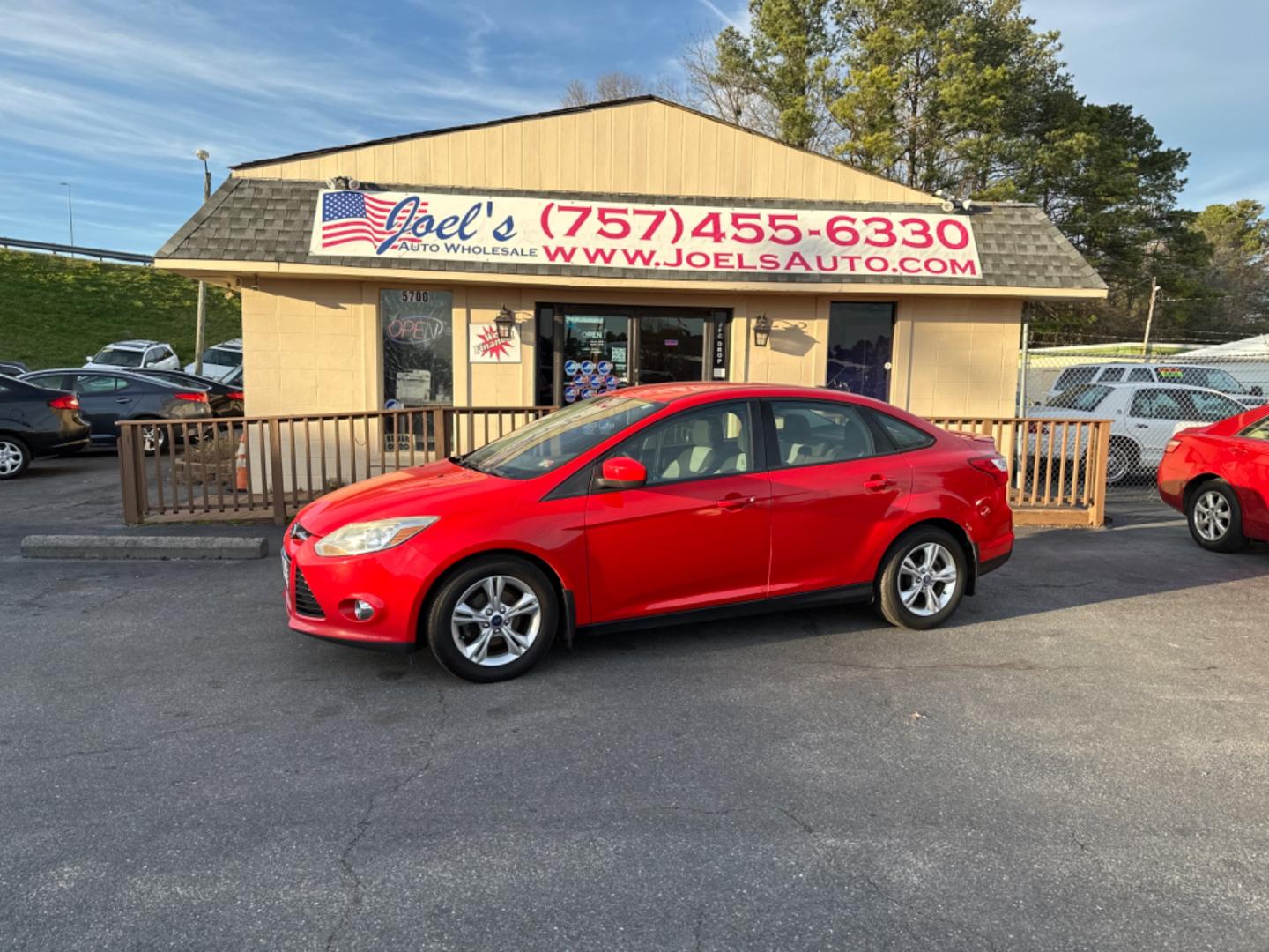 2012 Red Ford Focus SE Sedan (1FAHP3F26CL) with an 2.0L L4 DOHC 16V engine, located at 5700 Curlew Drive, Norfolk, VA, 23502, (757) 455-6330, 36.841885, -76.209412 - Photo#0