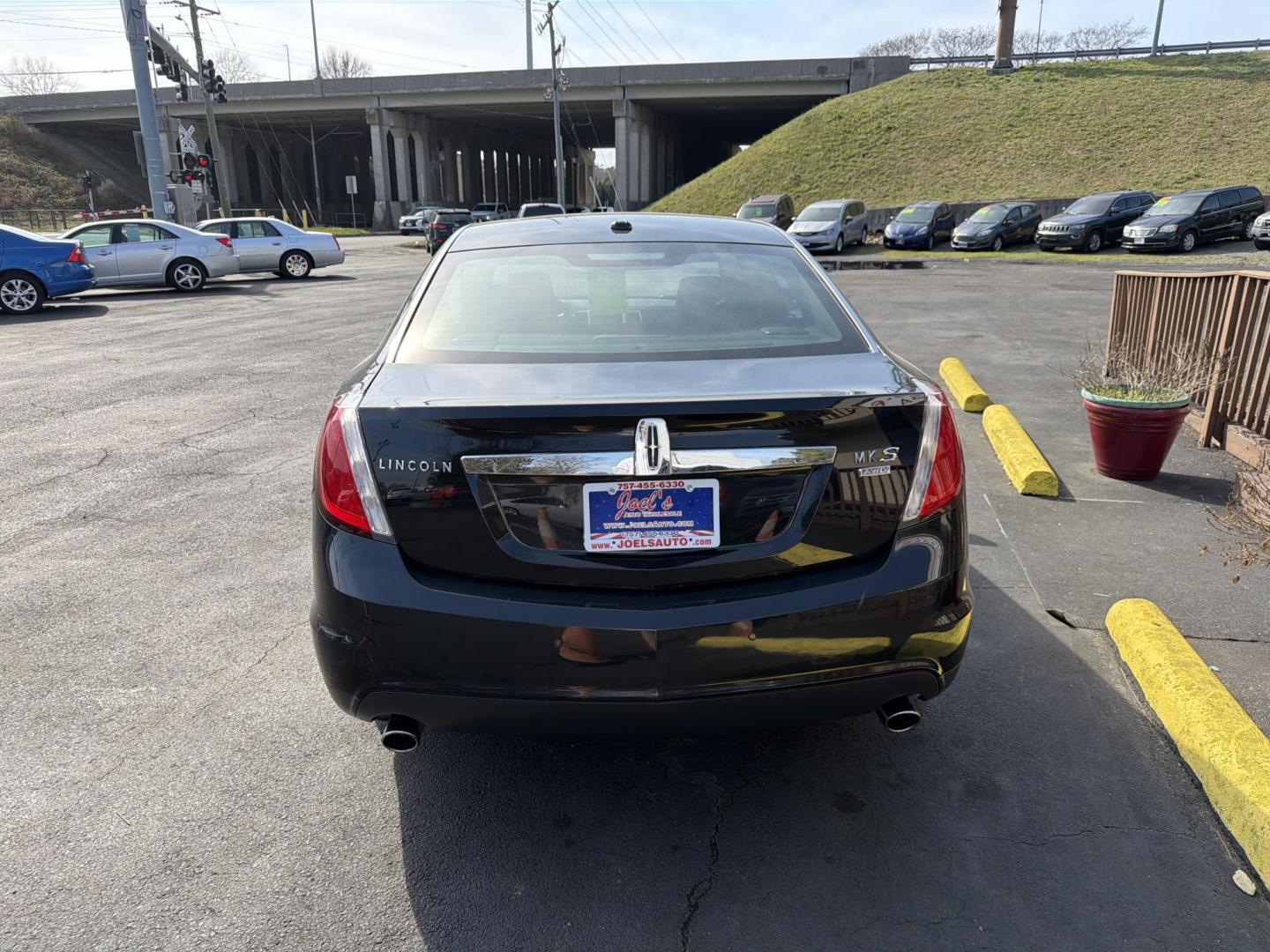 2009 Black Lincoln MKS AWD (1LNHM94R29G) with an 3.7L V6 DOHC 24V engine, 6-Speed Automatic Overdrive transmission, located at 5700 Curlew Drive, Norfolk, VA, 23502, (757) 455-6330, 36.841885, -76.209412 - Photo#2